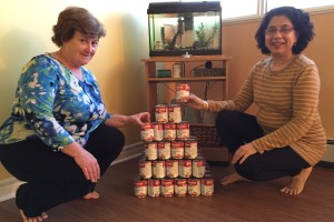 Gina and Amita add some cans of milk to our small but growing pyramid.